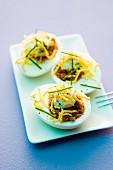 Devilled eggs filled with cheese and chives