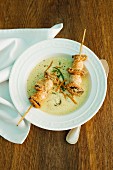 Curry foam soup with seafood skewers