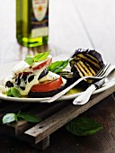Grilled tomatoes and aubergines with mozzarella, basil and olive oil