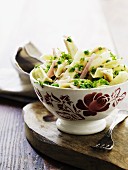 Penne pasta with Gorgonzola, peas, ham and parsley