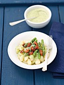 Gnocchi with basil pesto, asparagus and dried tomatoes