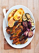 Grilled pork ribs with courgette, onion and baked potatoes