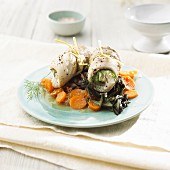 Pollock rolls with dill on a carrot and chard medley