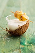 Coconut and yogurt soup served with a fruit skewer