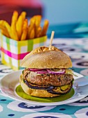 A lamb burger with aubergines and onions