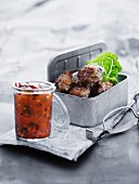 Chilly meatballs in a picnic tin with a dipping salsa