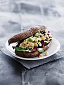 A wholemeal roll filled with salmon, avocado and radicchio