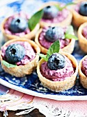 Mini croustades with a blueberry and cream cheese filling