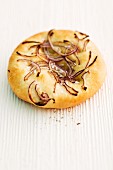 Focaccia with red onions on a wooden surface
