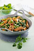 Fried spinach with chicken breast, peanuts and coriander