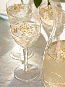 Elderflower syrup in glasses and a carafe