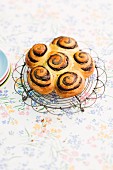 Poppy seed buns on a wire rack