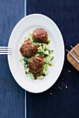 Goose burgers on a bed of creamy savoy cabbage