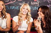 Young women drinking champagne in a bar
