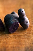 Purple potatoes on a wooden surface
