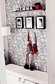 Black, white and red; floral wallpaper, gnome figurines, family photos and decorated bracket
