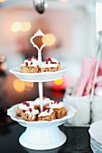 Pieces of cake on white china cake stand