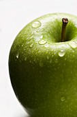 A freshly washed green apple