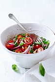 Cherry tomato salad with basil, onions and pine nuts