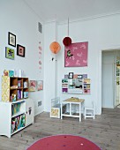 Child's bedroom with shelves, small table and bench