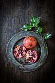 Pomegranates and a sprig of holly