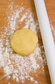 Shortcrust pastry and a rolling pin on a floured work surface