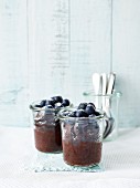 Chocolate cake in glasses with blueberries