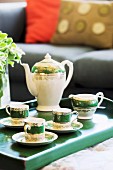 China tea set on green wooden tray
