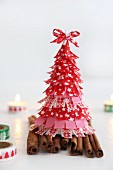 Christmas tree made from washi tape on cinnamon sticks and candles decorated with washi tape