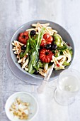 Pasta with wild garlic, tomatoes and olives