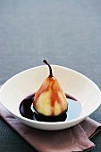 A poached pear in red wine sauce