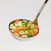Minestrone soup in a ladle