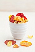 Vegetable crisps in a white ceramic cup