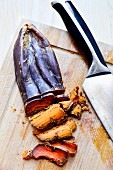 Bottarga (salted pressed fish roe, Sardinia) on a chopping board