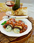 Aubergine roll with a herb filling and a vegetable sauce