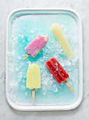 Various ice lollies on ice