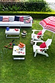 White outdoor furniture and accessories in red, white and blue on lawn