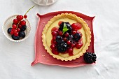 A tartlet with vanilla cream and mixed berries