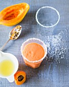 A smoothie made with papaya, lime, coconut and apricots