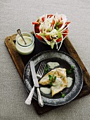 Chicken breast with cheese sauce and a raw vegetable salad