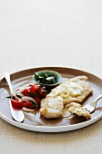 Grilled fish with a creamy sauce and tomato salad