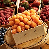 Yellow raspberries in a wooden box