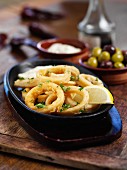 Fried squid rings with lemons and olives (Spain)