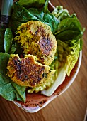 Couscous and courgette cakes on a bed of lettuce