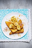 French toast with caramelised bananas and slivered almonds