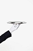 A butler holding an empty silver tray