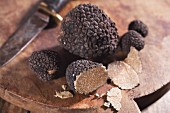Black truffles, sliced, on a chopping board