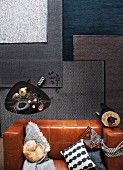 Rugs in shades of grey in living room with coffee table and leather sofa