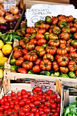 Various tomatoes in crates at a market