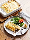 Gratinated pancakes with cheese and mushrooms